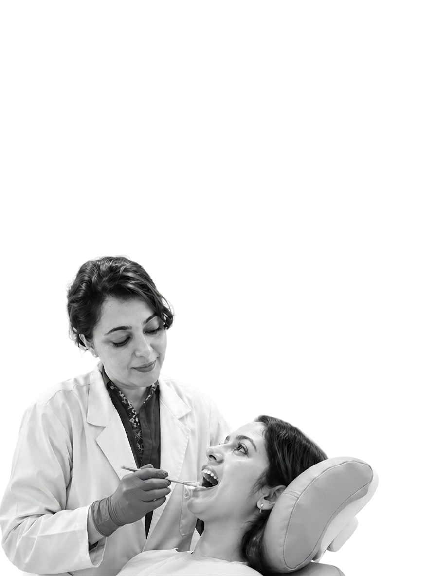 A doctor at Dr. Bouri's Dental Clinic examining a patient in the chair